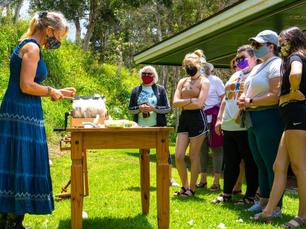 a group of people that are standing in the grass